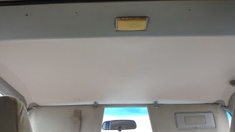 1995 Ford Bronco - Interior view of the headliner and sun visors in a vehicle.