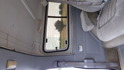 1995 Ford Bronco - Interior view of a vehicle with a window looking out onto a rural landscape.