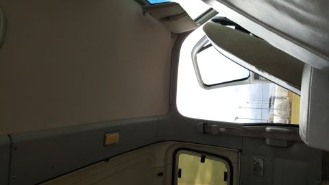 1995 Ford Bronco - Interior view of a vehicle, looking towards the passenger side with the door ajar.