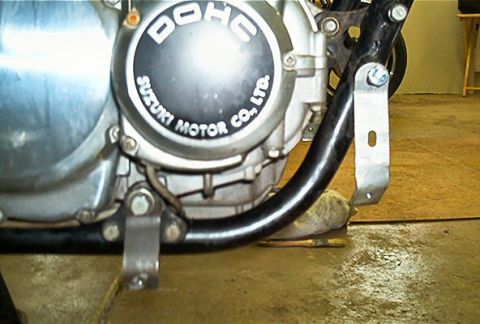 1985 Ford Crown Victoria LTD - Detail of a Suzuki motorcycle engine, showing the DOHC designation and manufacturer's name.