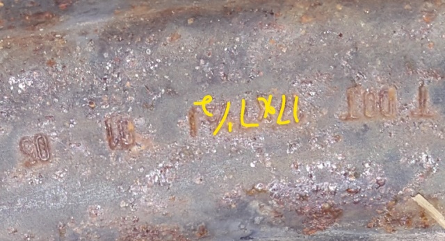 Rusted metal part with stamped markings '90', '10', '17x7J', and 'DOT T'