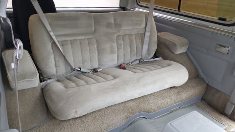 1995 Ford Bronco - The rear bench seat of a 1995 Ford Bronco, plush upholstery and seatbelts.