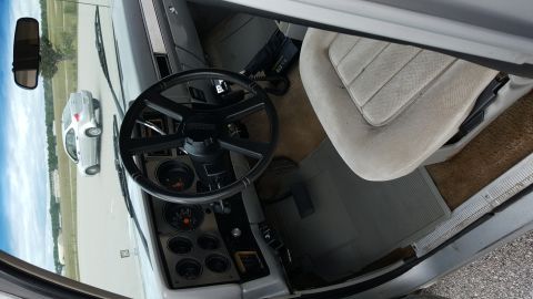 1995 Ford Bronco - Interior view of an older pickup truck, with a silver car seen through the windshield.