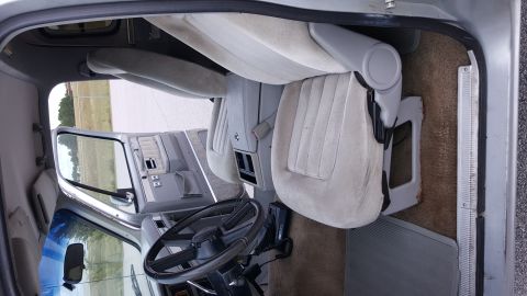 1995 Ford Bronco - The interior of the vehicle shows light-colored seats and a tan carpet.