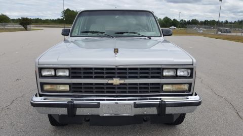 1995 Ford Bronco - This silver SUV is shown from the front, a prominent Chevrolet emblem on its grille.