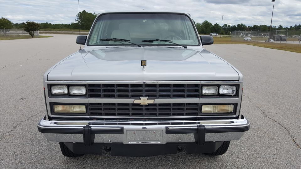 Silver SUV front view with Chevrolet emblem on grille