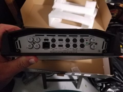 1994 Ford Bronco - Rear panel of a car amplifier shows various input and control knobs, along with text indicating it was designed and engineered in the U.S.A.