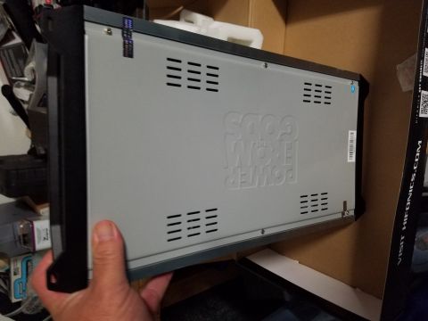 1994 Ford Bronco - Car stereo amplifier with 'POWER FROM GODS' embossed on the side, held by a hand.
