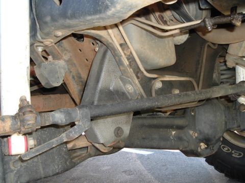 1989 Ford Bronco - Close-up view of the undercarriage, focusing on the steering and suspension system.