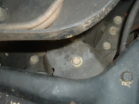 1989 Ford Bronco - Detail shot of a vehicle's suspension or frame component, showing bolted connections.