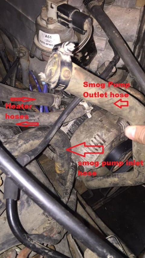 1994 Ford Bronco - Close-up view of engine bay components, including labeled smog pump and heater hoses.