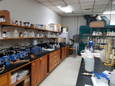 1994 Ford Bronco - A laboratory scene showing extensive equipment and chemical supplies on benches and shelves.