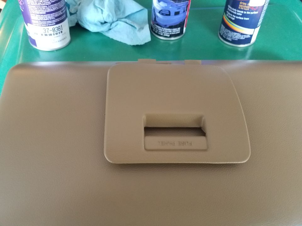 Tan dashboard panel with cutout labeled 'FUSE PANEL'