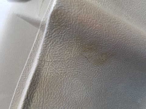 1994 Ford Bronco - This photo shows a close-up of a cracked dashboard trim piece with some discoloration.