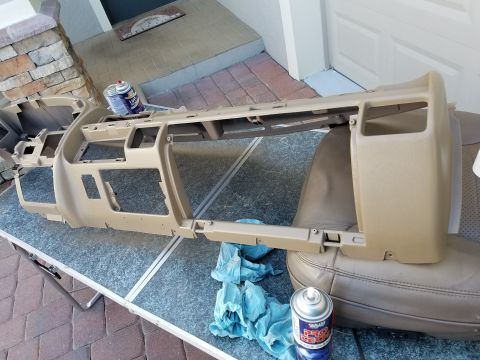 1994 Ford Bronco - Dashboard assembly removed for repair, placed on a table outdoors.