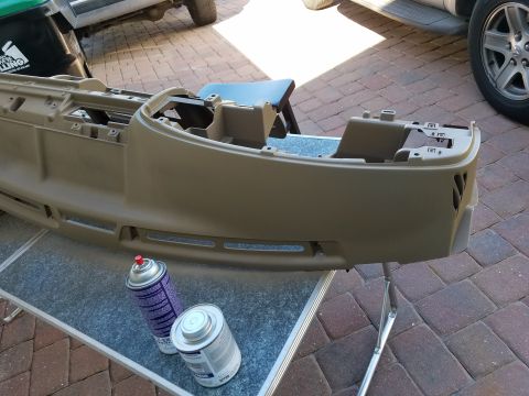1994 Ford Bronco - A tan dashboard assembly is shown with spray cans nearby, suggesting a repair or refinishing process.