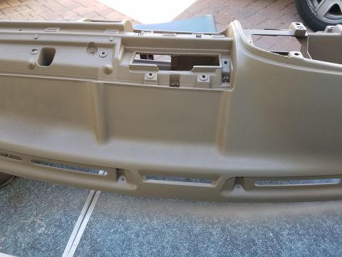 1994 Ford Bronco - This is a tan dashboard part, likely from a vehicle's interior, showing various vents and mounting points.