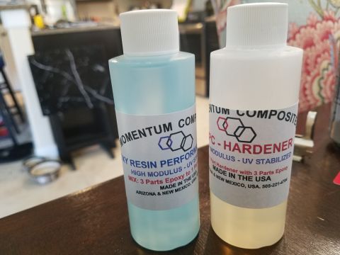 1994 Ford Bronco - Two bottles of epoxy resin and hardener are shown, labeled with product information and manufacturer details.
