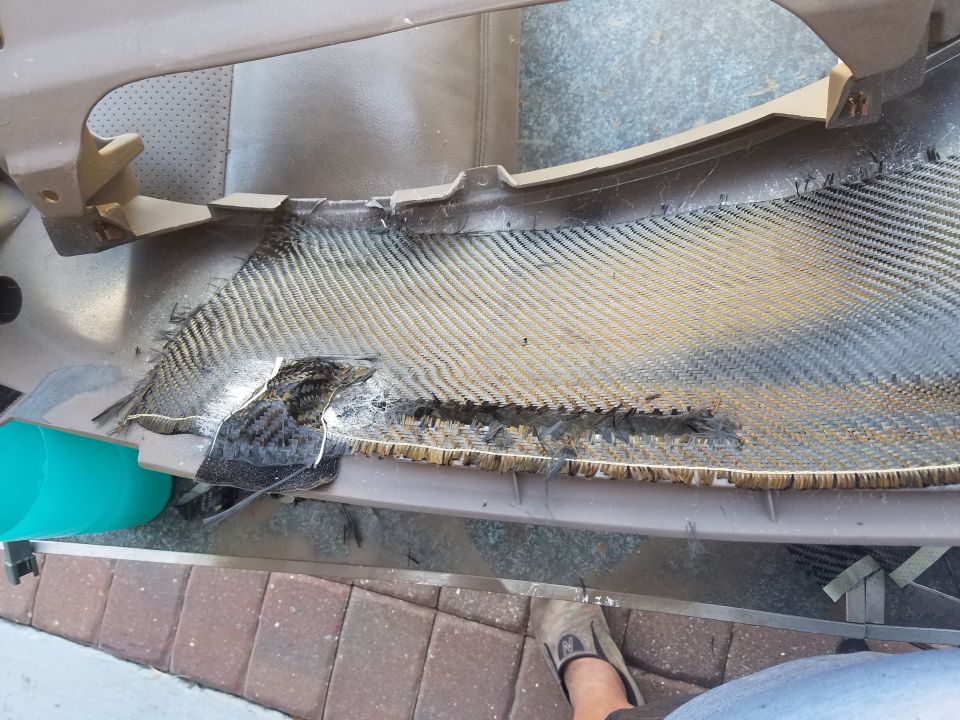 Photo of a damaged carbon-fiber automotive panel