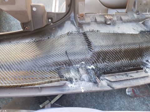 1994 Ford Bronco - Dashboard panel shows extensive damage and a carbon fiber patch with adhesive.