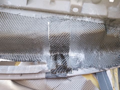 1994 Ford Bronco - Carbon fiber patch repair on a vehicle's dashboard interior, with visible weave and frayed edges.