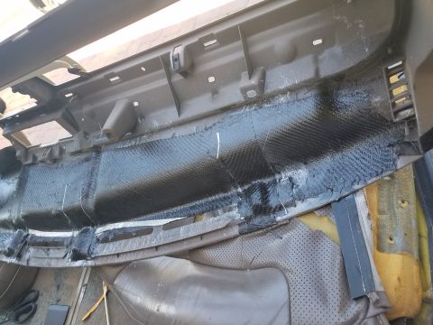 1994 Ford Bronco - The dashboard is being repaired with a carbon fiber wrap and tape, revealing its internal structure.