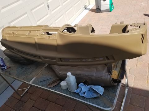 1994 Ford Bronco - Dashboard assembly is laid out on a table with cleaning supplies and a car seat nearby.