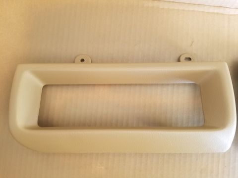 1994 Ford Bronco - A beige plastic dashboard trim piece is shown against a neutral background.