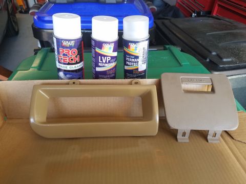 1994 Ford Bronco - Dashboard trim pieces and spray cans for automotive interior repair.