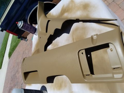 1994 Ford Bronco - Interior trim pieces being prepped for painting with spray cans nearby.