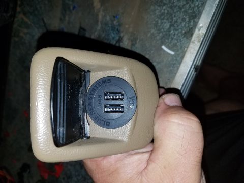 1994 Ford Bronco - Dual USB ports installed in a vehicle's interior trim panel.