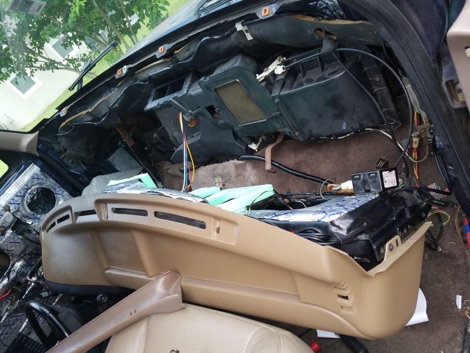 Disassembled dashboard of a 1992 Ford Bronco, showing exposed wiring and insulation