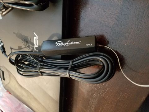 1994 Ford Bronco - A black Retro Antenna HPA1 unit with attached cables is shown on a dark surface.