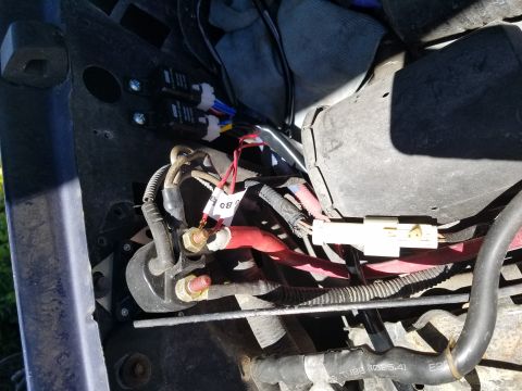 1994 Ford Bronco - Detail of electrical components and wiring within a vehicle's engine compartment.