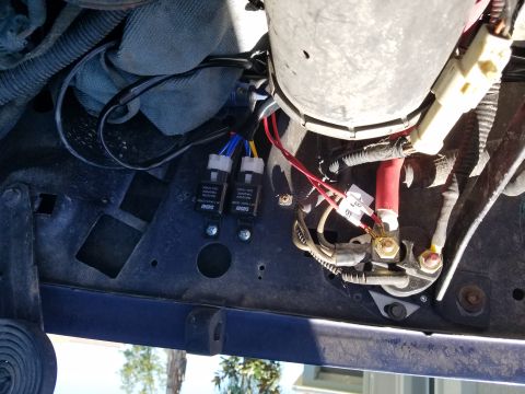 1994 Ford Bronco - Close-up view of headlight relays and associated wiring, likely from a Ford Bronco.