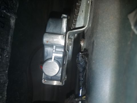 1994 Ford Bronco - A close-up view of a vehicle's door latch mechanism, showing metal components and wiring.