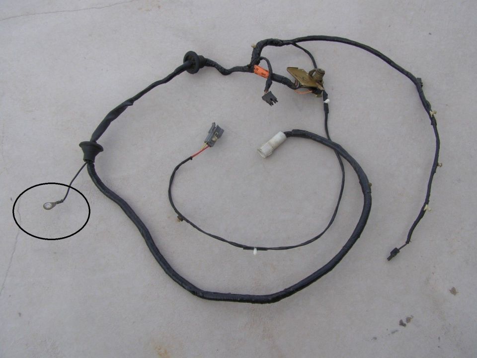 Vehicle wiring harness with connectors and a ground ring terminal