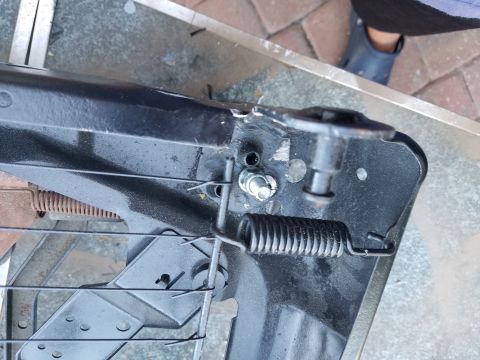1994 Ford Bronco - This is a close-up view of a vehicle seat's internal mechanism, showing springs and mounting hardware.