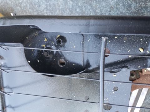 1994 Ford Bronco - Close-up of a black metal seat frame, showing its construction and mounting points.
