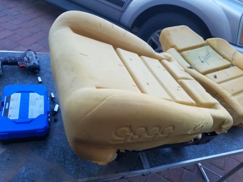 1994 Ford Bronco - Close-up of vehicle seat foam with tools and a toolbox on a table.