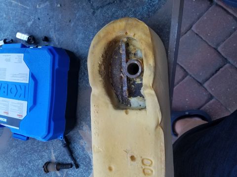 1994 Ford Bronco - A close-up view of worn car seat foam reveals a metal bracket and mounting hardware.