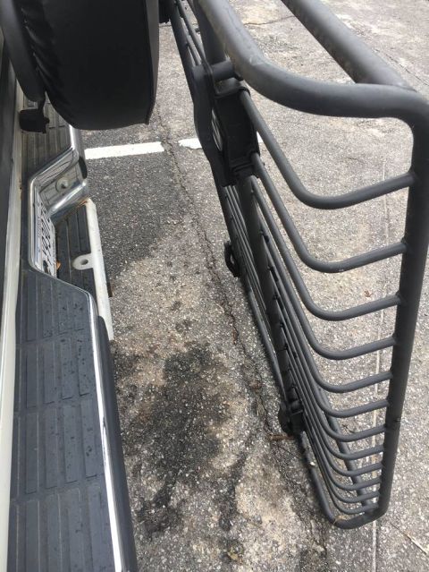 1988 Ford Bronco - The rear bumper and spare tire carrier are visible, along with a large brush guard.