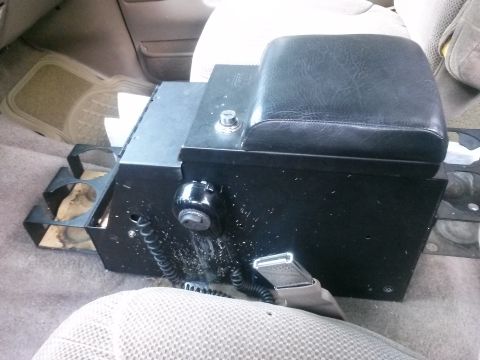 1996 Ford Bronco - Interior view of a vehicle's center console, showing a black armrest and storage unit.