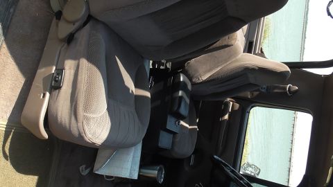 1996 Ford Bronco - Interior view of a vehicle's front seats and dashboard area.