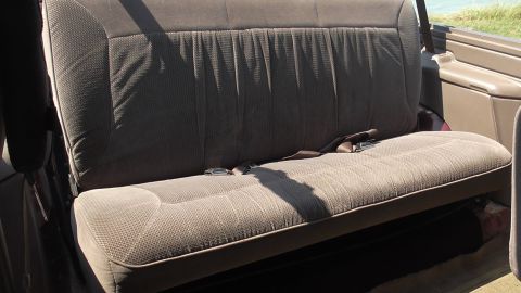 1996 Ford Bronco - Interior view of a brown fabric rear bench seat with seatbelts visible.