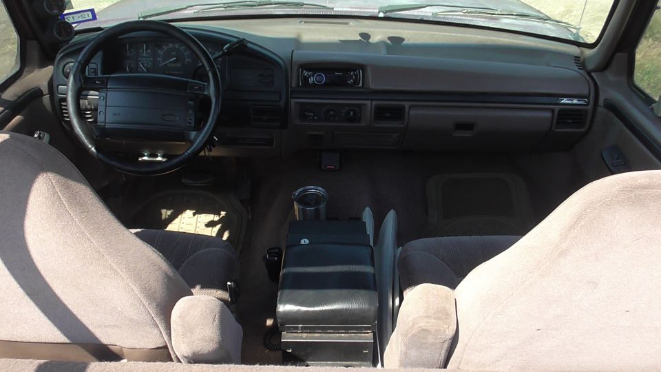 1996 Ford Bronco interior showing dashboard, steering wheel, and seats
