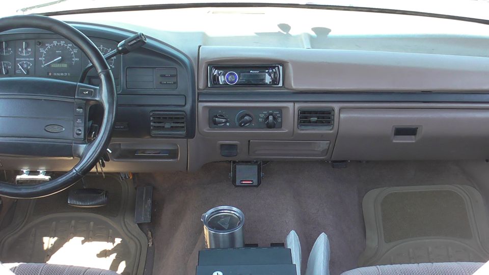 Dashboard and steering wheel of a truck, showing the radio and climate controls