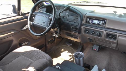 1996 Ford Bronco - The interior of a 1996 Ford Bronco, its dashboard, steering wheel, and seating.