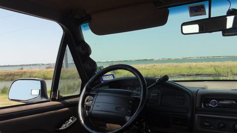 1996 Ford Bronco - Interior view of a 1996 Ford Bronco, looking out at a body of water.