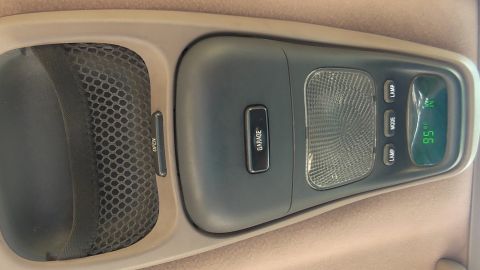 1996 Ford Bronco - Interior overhead console features a garage door opener button and a digital display showing the temperature.